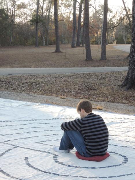 Phillip Cork, A’14 sits in meditation at a previous retreat. The Emmaus Retreat is annually held in the spring to provide a break for students and a chance to find peace of mind in silence. 