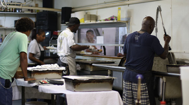 Residents at the New Orleans Mission work in the shelter’s kitchen. The New Orleans Mission is one of many shelters in the city providing homeless individuals with a method to seek permanent housing.