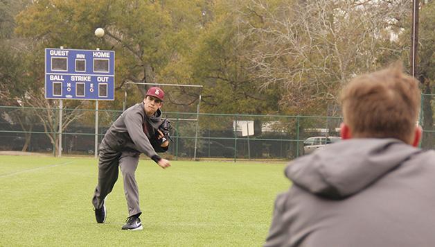  John Daley, accounting freshman, throws a fastball to Head Coach Doug Faust. The men’s baseball team is heading into a critical strecth of conference games this month.