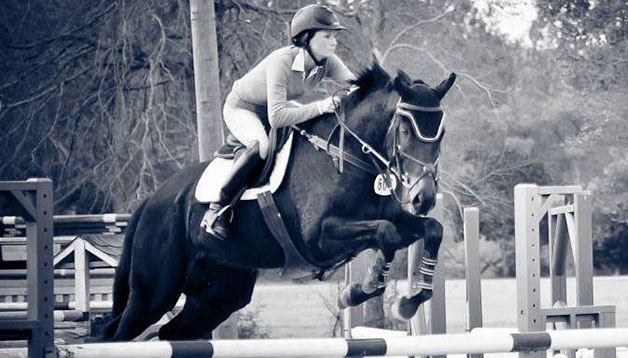 Megan Burgess Torres, coach of Loyola’s new equestrian team and former college equestrian, clears a hurdle.  Loyola’s team will train at Torres’ farm in Covington, Louisiana.