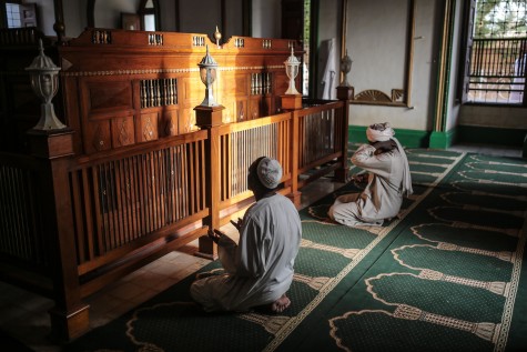 Sudanese men pray at the tomb of Al Mahdi, a leader of rebellion against the British and a self-declared Caliph, in Omdurman Sudan, Friday, April 10, 2015. 