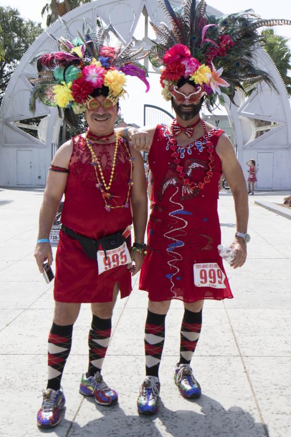 Rick Rheauxme, left, and Bill Adair, right, arrive in red in Armstrong Park for the annual Red Dress Run. The annual event, which takes place in the French Quarter, raises over a million dollars for over 100 charities in the greater New Orleans area. Photo credit: Zach Brien