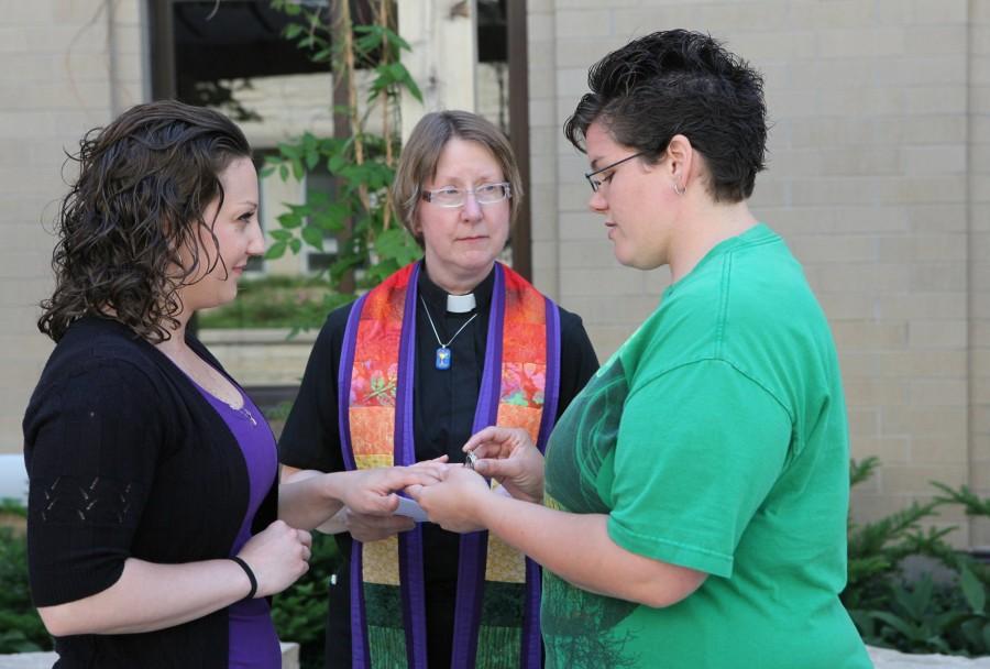 Courtney Beckwith, left, and Amber Beckwith are married by Rev. Lori Hlaban on Monday, June 9, 2014, in Waukesha, Wisc. The couple had their names changed legally after an earlier commitment ceremony. 