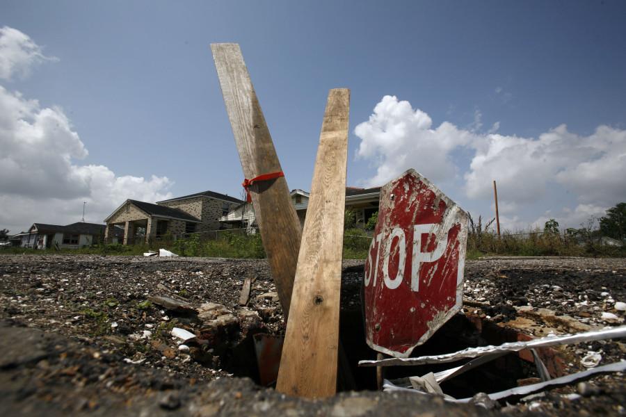 Boards and a stop sign mark an open manhole in the devastated Lower 9th Ward of New Orleans, Louisiana, April 11, 2007. The area still remains largely devoid of residents. (Jose More/Chicago Tribune/MCT)