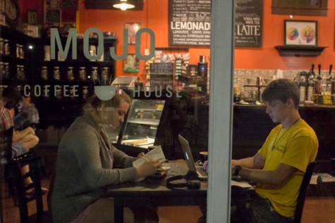 atilyn Woltz and Dillon Tauzin, Loyola seniors, enjoy drinks while studying. They represent the growing trend of frequenting coffee shops.