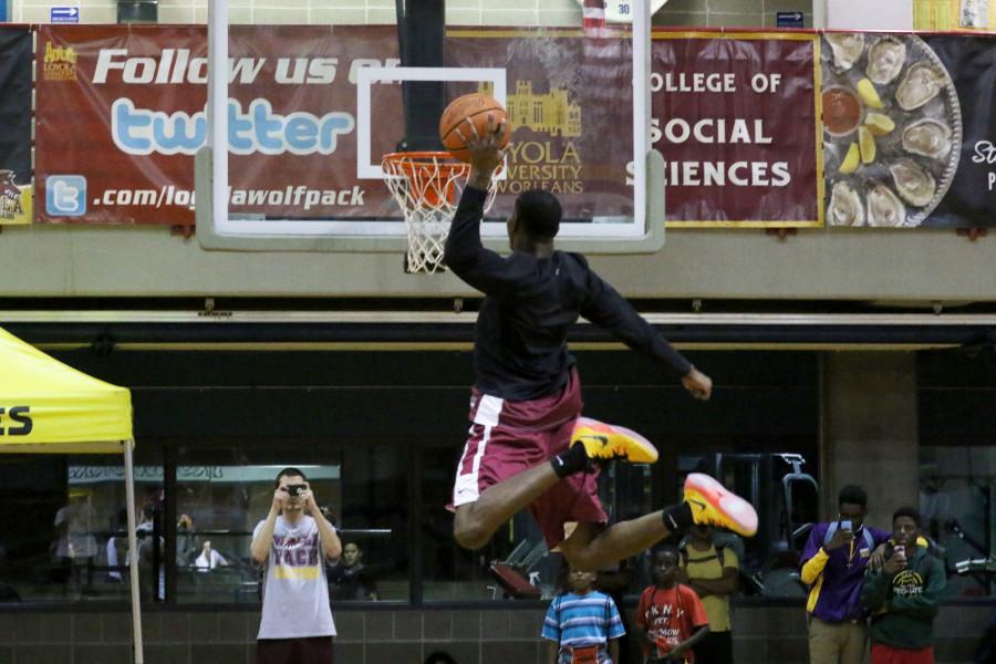 Junior guard/forward Johnny Griffin Jr. dunks the ball during warmups at Fan Fest on Thursday in the Den. The event featured scrimmages by the mens and womens basketball teams, a three point competition and crowd activities.