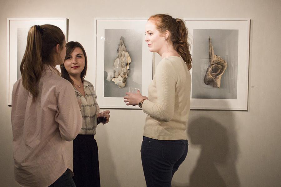 Molly Helie, left, a visual arts senior Autumn Cormier, center, a visual arts junior, and Kristin Anabell, right, mingle by Lee Deigaards work in the Collins C. Diboll Gallery on the fourth floor of the Monroe Library at an opening for artists Lee Deigaard and Rachel Jones Deris. Deigaards work is drawings and photogenic drawings largely inspired by trees in New Orleans and Deris will display her new paintings. Photo credit: Taylor Galmiche