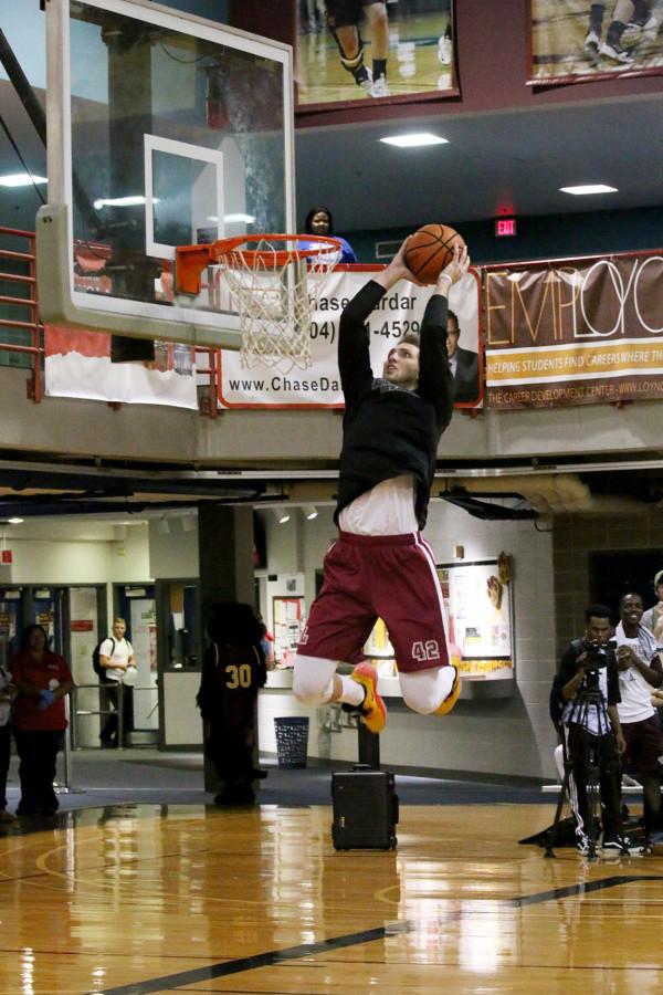 Junior guard Nate Pierre dunks the ball during mens warmups at Fan Fest on Thursday in the Den. The event featured scrimmages by the mens and womens basketball teams, a three point competition and crowd activities.