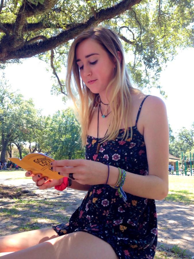 Charlotte Preuss, mass communication freshman, reads over the Nola Bucket List guidebook. The guidebook is intended for newcomers who are looking to explore the city. Photo credit: Zayn Abidin