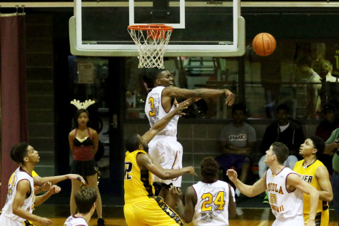 Junior forward Johnny Griffin Jr. blocks the shot of a Xavier guard in a Thursday night game in the Den. The Pack will look to carry their defensive intensity to conference play, starting on Dec. 18 against Louisiana State University at Alexandria (LSUA).