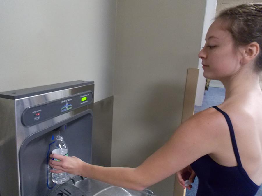 Julia Maples, music industry studies senior, refills her water bottle before ballet class in Roussel Hall. 