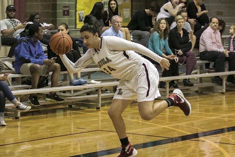 Loyola junior guard Caroline Gonzalez lunges for a loose ball in a game against Blue Mountain College in the Den. The women won 95-57.