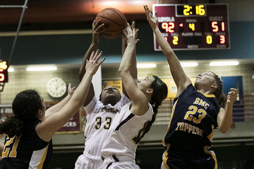 Loyola freshman forward Nyree Grant pulls in a rebound at the end of the fourth quarter in a game against Blue Mountain College in the Den. The women won 95-57.