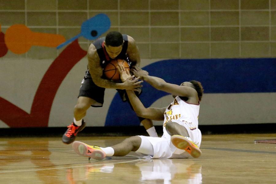 Loyola freshman TreVon Jasmine struggles for a loose ball in the second half of their game against William Carey University in the Den Jan 23, 2016. The men lost 71-83 to SSAC rival William Carey, who ranks first in the conference.