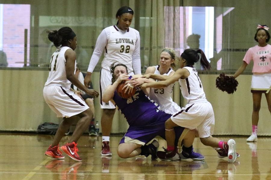 Megan Worry, Loyola freshman guard, center, and Zoie Miller, Loyola sophomore guard, right, struggle with Madison Steppee, Bethel University freshman guard, for the ball in the second half of their game in the Den. Bethel University Lady Wildcats, which are ranked no. 4 in the NAIA, defeated no. 25 Loyola  Wolfpack 71-52.