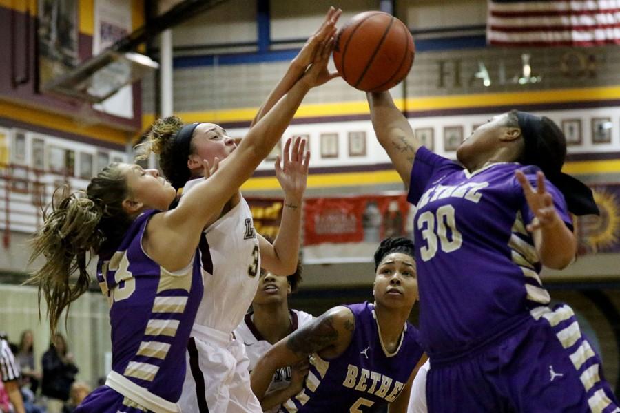 Jackie Anderson, Loyola junior guard, struggles with Shamon Pearson, Bethel University sophomore guard, for the ball in the second half of their game in the Den. Bethel University, which is ranked no. 4 in the NAIA, defeated no. 25 Loyola 71-52.