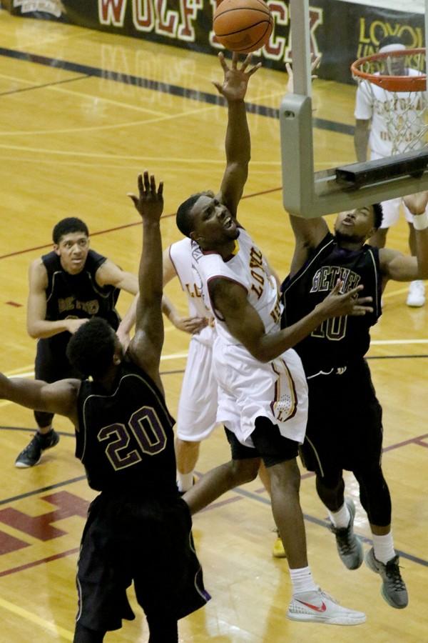 Johnny Griffin Jr., Loyola junior guard, drives the lane for a layup in the second half of their game against SSAC rival Bethel University. Griffin had 15 points en route to a 84-79 victory in their last home game of the season.