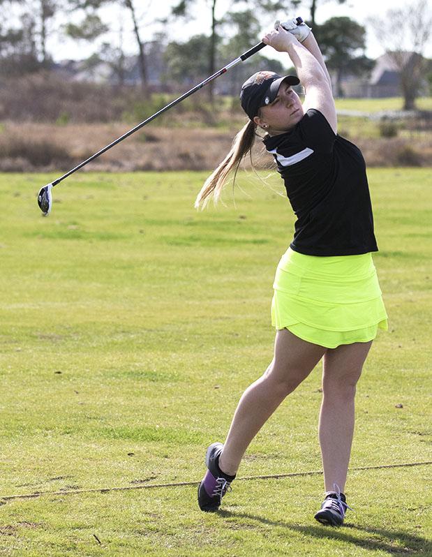 Alexis Hazard, junior biology major, right, practices at Oak Harbor Golf Course in Slidell. Both the men and women’s golf team are preparing for a tournament at Oak Harbor Mar. 7-8. Photo credit: Zach Brien