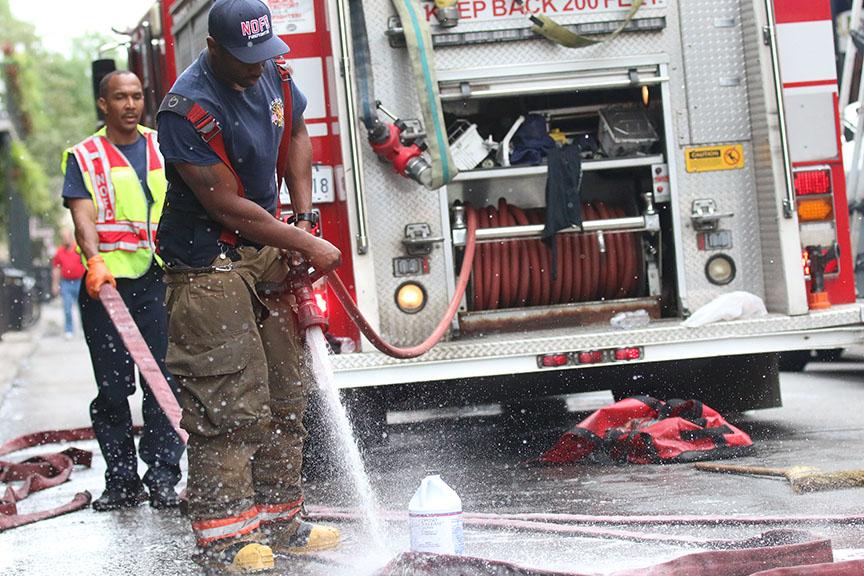 Fire fighters clean off their hoses on Decatur street. Around 9 AM on Wednesday morning the New Orleans fire department responded to a three-alarm fire at Fiorella's Cafe on the 11 hundred block of Decatur Street.