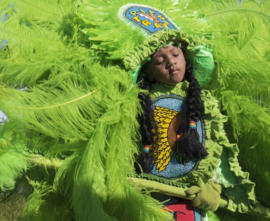 Joshua Charles Jr. of the Red Hawk Hunters listens to the Cha Wa Band on the Jazz and Heritage Stage at the 2016 New Orleans Jazz and Heritage Festival. Skies were clear and weather was mild for the first weekend of the annual festival.