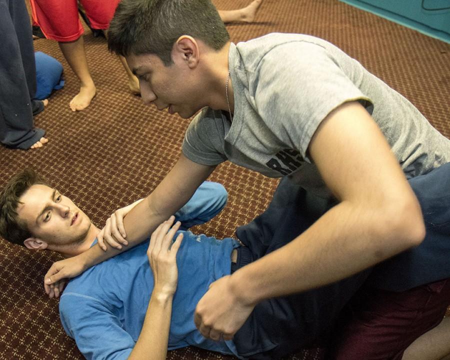 Rafael Polanco, English digital media sophomore (right), goes over technique with Tyler Wann, English writing freshman (left), during mixed martial arts club practice. The club is placing more emphasis on technique in its training as the season came to a close this year.