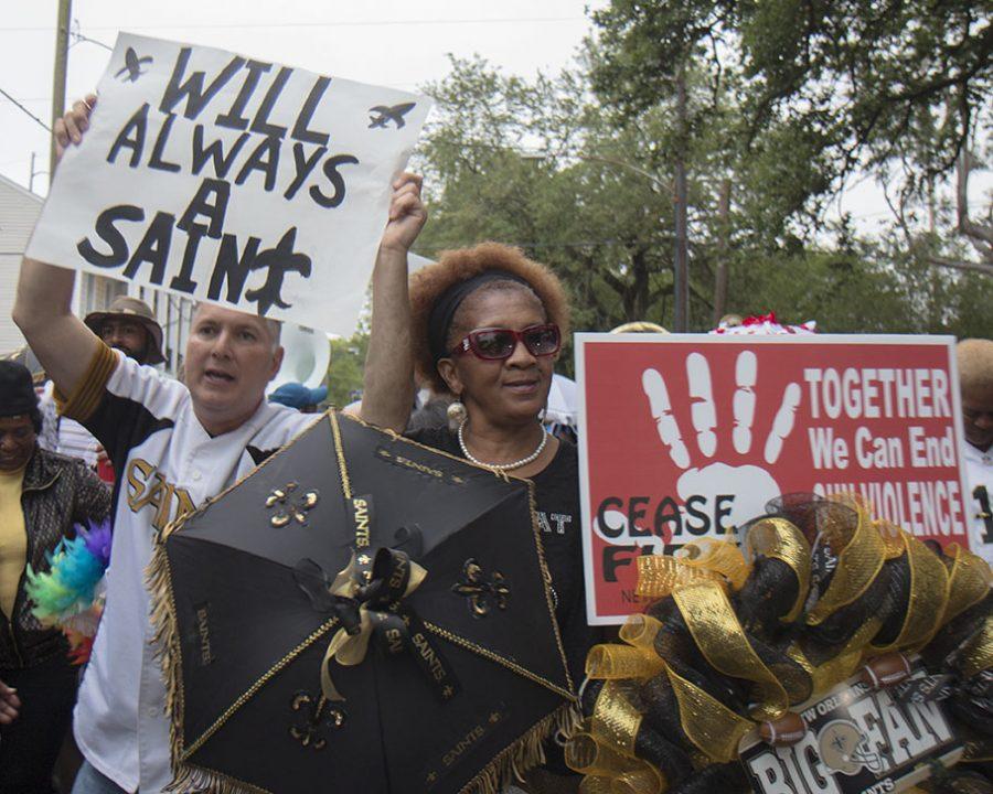 Larry Rolling, left, and Duchess Hearst, right, parade down Camp street in the Lower Garden District as part of the second line for Will Smith on April 15. Smith, a former New Orleans Saint, was shot killed in an altercation after a minor traffic accident in the Lower Garden District on April 9.