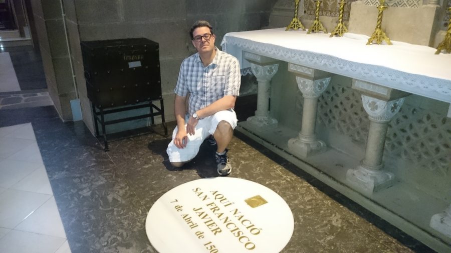 John Sebastian, vice president for Mission and Ministry, kneels next to the birthplace of St. Francis Xavier. Sebastian visited important sites from Ignatius life this summer. Photo credit: Courtesy of John Sebastian