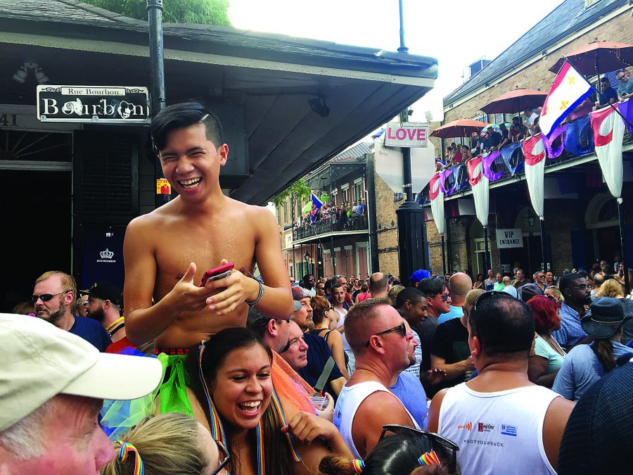 Calvin Tran, music therapy/pre-health sophomore
and Samantha Menendez, psych/pre-health junior team up for a better view during the Southern Decadence Walking Parade Sunday afternoon. The weekend rain didnt stop huge crowds from celebrating. Photo credit: Molly Olwig