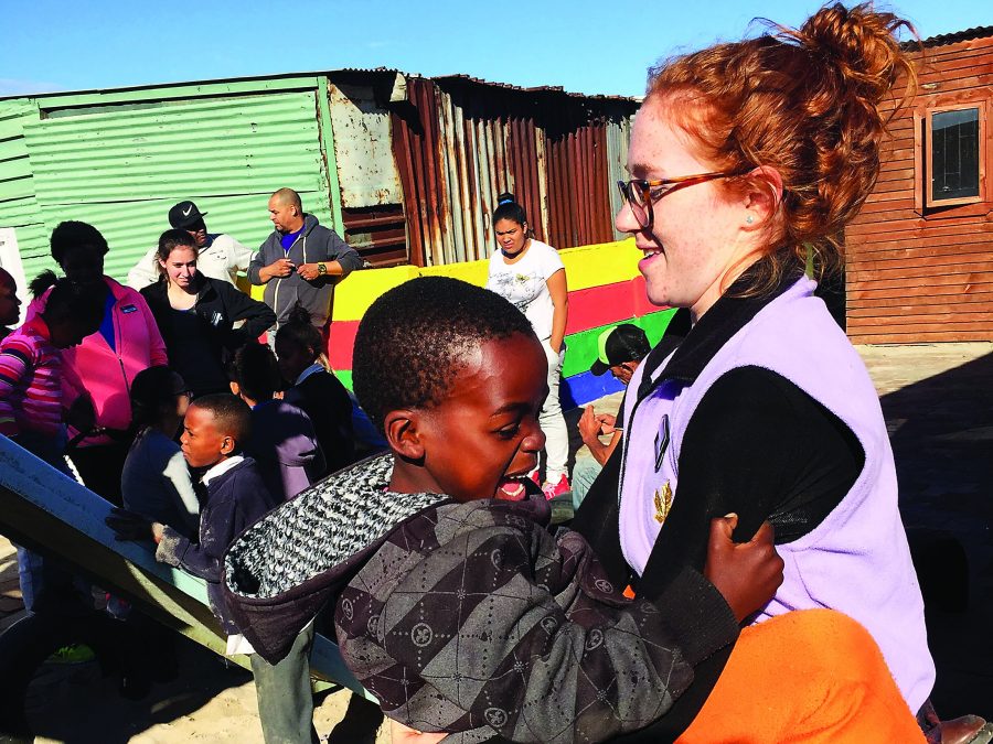 Emily Mastin A'16 plays with a child in South Africa. Mastin worked there with Iggy Vols this summer. (Image credit: Emily Mastin)