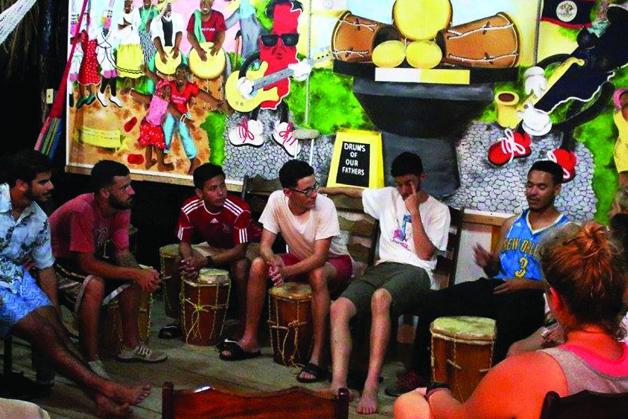 Loyola students and alumni teach drumming at a music program they established in Belize. The Belize trip was established because there were previously no university programs for music in the country. Photo credit: Courtesy of the Rev. Ted Dzak S.J.
