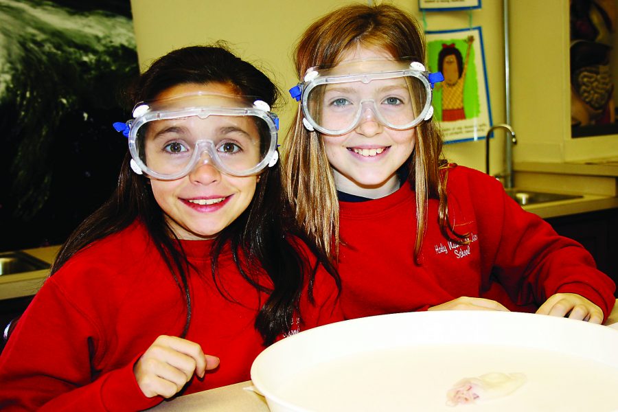 Two Holy Name of Jesus students pose in a science class. The school celebrated its 125th anniversary this year.