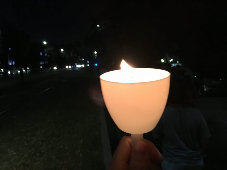 A student holds a candle at Take Back the Night 2016 while marching through Tulane Universitys campus. Take Back the Night is a collaboration between New Orleans universities. Photo credit: Lester Duhe