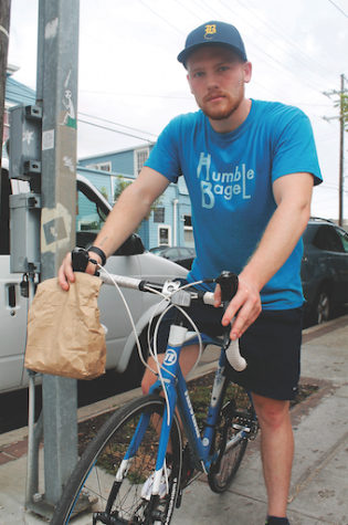 Brendan Dodd, also known as Bagel Boy,  is seen here performing his usual bagel deliveries across Uptown New Orleans.  Dodd delivers leftover bagels from Humble Bagel to people who request them on Tulane Classifieds. 