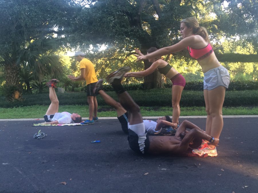 The cross country team does ab exercises after a run in Audubon Park in late August. The team finished the season with new records and few injuries. Photo credit: Colleen Dulle