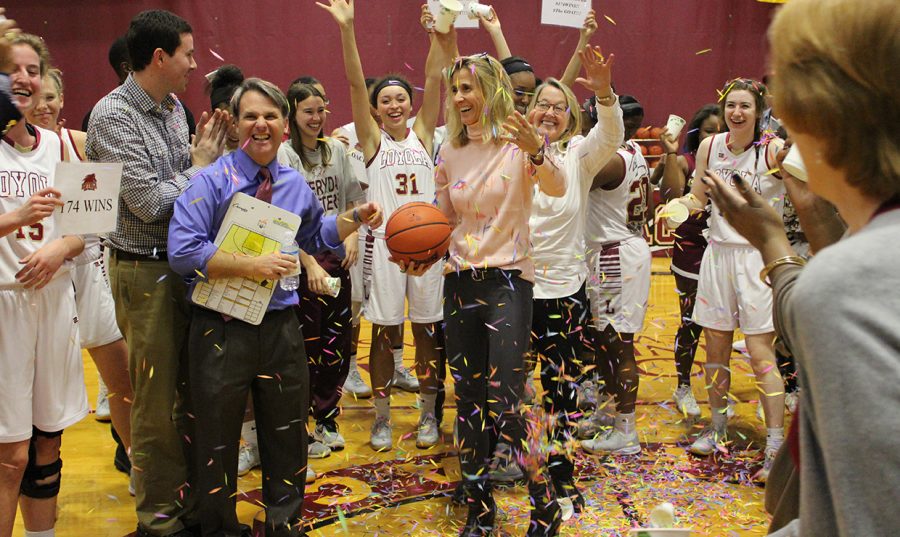 Cissy Petty, vice president for student affairs, throws confetti on Coack Kellie Kennedy after Monday's game, when Kennedy became the winningest coach in Loyola history. Photo credit: Loyola Athletics