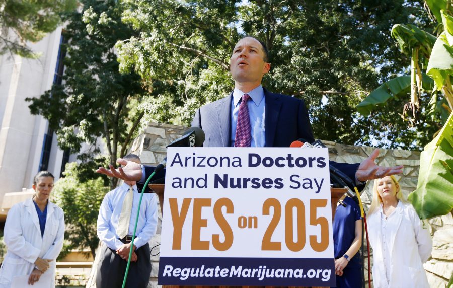 J.P. Holyoak, chair of the Campaign to Regulate Marijuana Like Alcohol, speaks at a news conference as he is joined by a host of doctors and nurses gather at the Arizona capitol to endorse Prop 205, the legalization of recreational marijuana, Wednesday, Oct. 26, 2016, in Phoenix. (AP Photo/Ross D. Franklin)