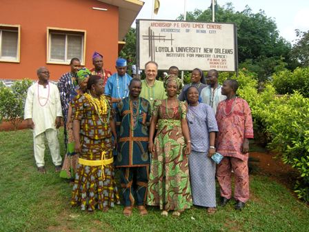 Dr. Thomas Ryan poses in Africa with locals. Photo credit: Loyola University New Orleans