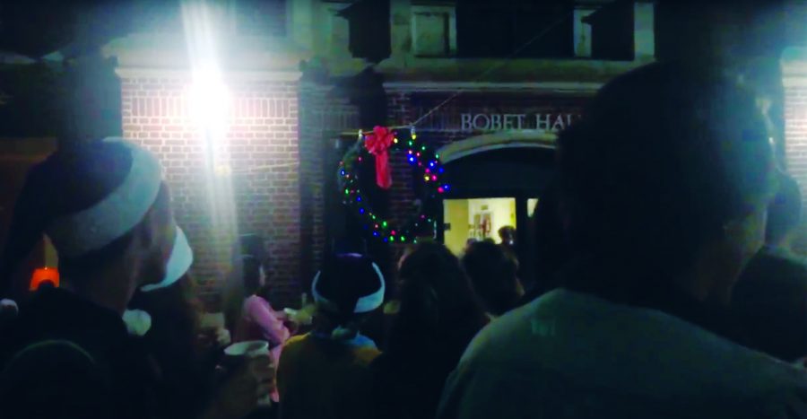 A lit Christmas wreath slides down a rope in front of Bobet Hall to ring in a new liturgical year. The Advent Wreath Drop is a longstanding Loyola tradition. Photo credit: Colleen Dulle