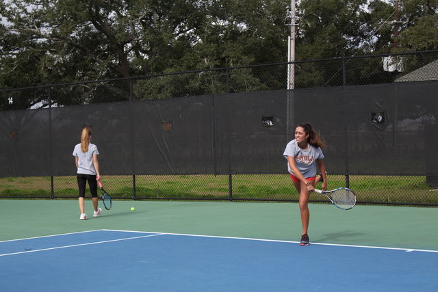 Nadja Ochsner, pre-med freshman and Miranda Cano, biology freshman practice at City Park. The tennis season is now in full swing. Photo credit: Alliciyia George