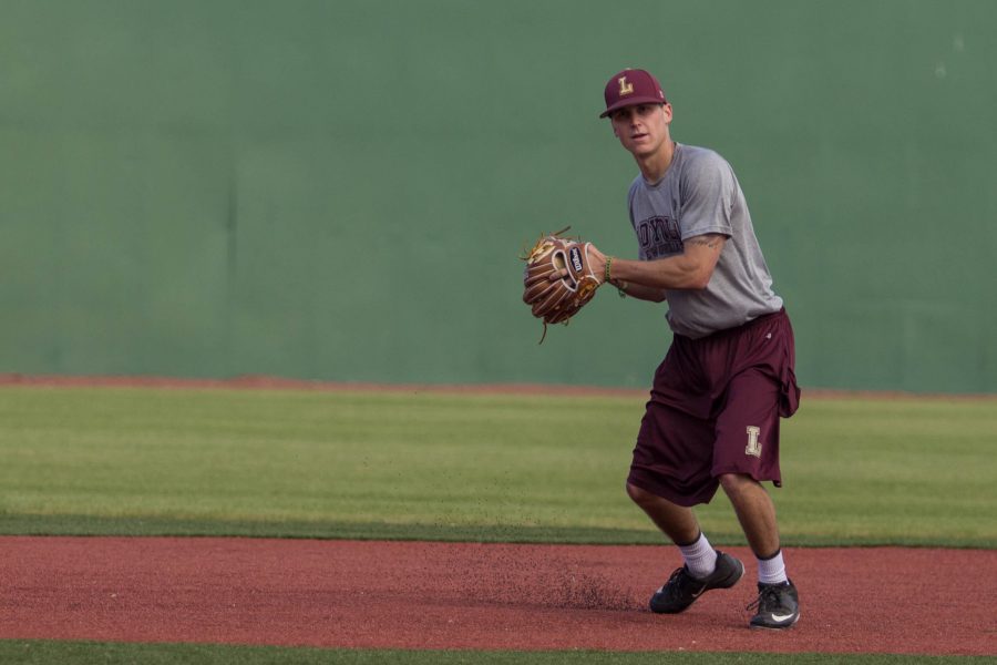 Blake Toscano, Loyola Wolfpack shortstop and business major, throws a baseball during practice, at the John A. Alario Sr. Event Center baseball diamond in Westwego, January, 14. The senior said he hopes to see some participation from Loyola students during the season. Photo credit: Osama Ayyad