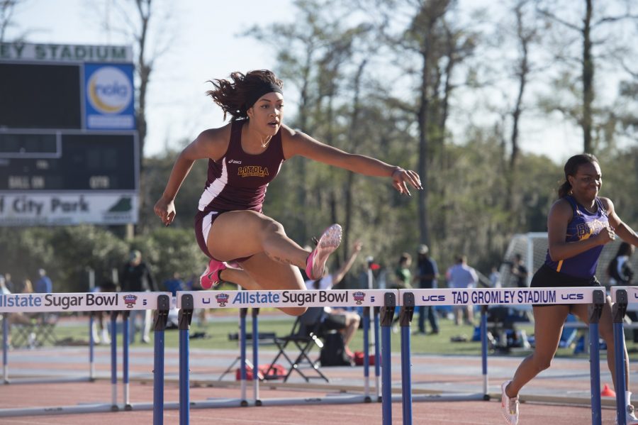 Sophomore Asia Marie Kelly jumps over a hurdle at the Tulane Twilight Invitational on March 4, 2016. Photo credit: Courtesy of the Athletic Department
