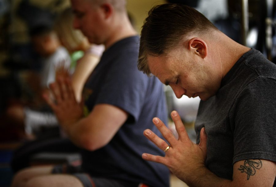 U.S. Marine Sgt. James Bernard, 25, meditates during a yoga class at the Naval Medical Center in San Diego, California, on June 10, 2013. Bernard suffers from PTSD and a traumatic brain injury after deployments to Iraq and Afghanistan. The one-hour yoga class is designed to calm the mind, increase flexibility and improve physical strength. (Don Bartletti/Los Angeles Times/MCT)