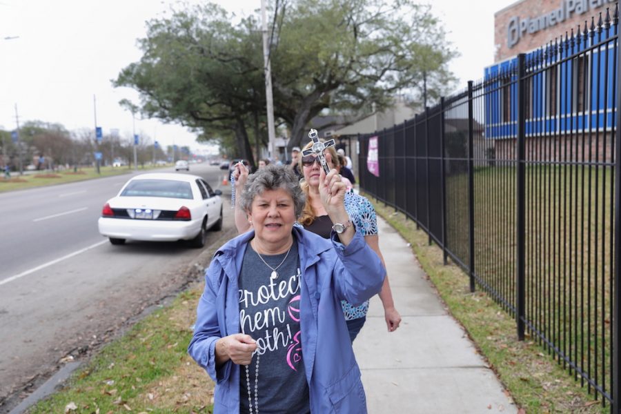 Karen Arnold, New Olreans native who frequently participates in anti-abortion events, prays with other protesters February 12, 2017, near the entrance to the South Claiborne Avenue Planned Parenthood location, New Orleans, Louisiana as part of a national protest against the establishment.