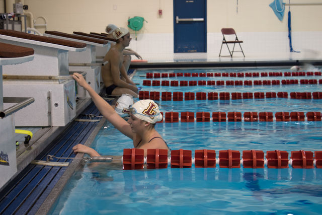 A Loyola swimmer gets out of the water after her practice. The Wolf Pack head to the NAIA Swimming and Diving Championships on March 1. Photo credit: Tristan Emmons