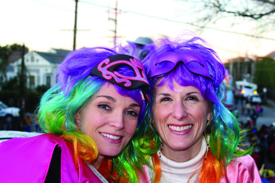 Jennifer Jeanfreau (right) and friend at a previous Mardi Gras. Both ready to ride in Muses wearing colorful wigs and smiles.