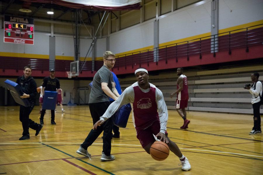 Nick Parker, business junior, races to the hoop during practice on March 10. The Wolf Pack take on the William Penn University Statesmen on Wednesday, March 15 at 8:00 p.m. at Municipal Auditorium in Kansas City, Missouri. Photo credit: Osama Ayyad