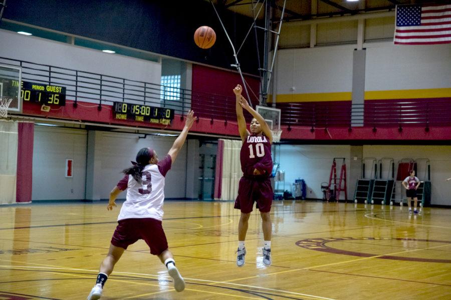 Zoie Miller, mass communication junior, takes a jump shot against Di'Mond Jackson, biology and pre-med junior, during practice on March 10. The Wolf Pack face off against the Montana  State University-Northern on Thursday March 16 at 7:00 p.m. at the Rimrock Auto Arena in Billings, Montana. Photo credit: Osama Ayyad & Brian Wollitz