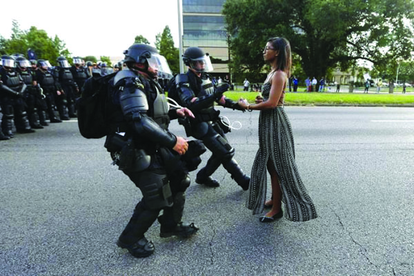 Protestor Ieshia Evans is detained by law enforcement near the headquarters of the Baton Rouge Police Department in Baton Rouge, Louisiana, U.S. July 9, 2016.  REUTERS/Jonathan Bachman