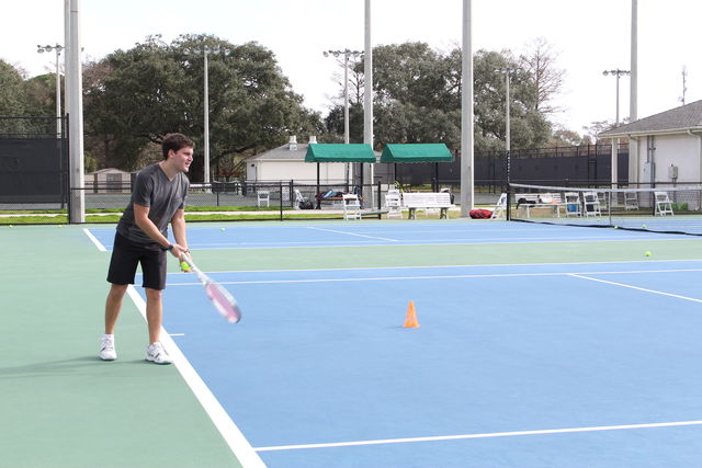 Loyola tennis player prepares to serve the ball. The tennis team is preparing for the conference championships on April 20. Photo credit: Alliciyia George