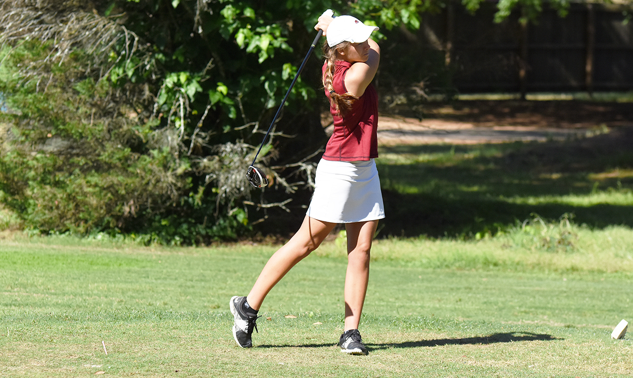 Sophomore Ashley Rogers finishes her drive during the conference championships. The Wolf Pack took fifth place at the tournament. Photo credit: Courtesy of Loyola Athletics